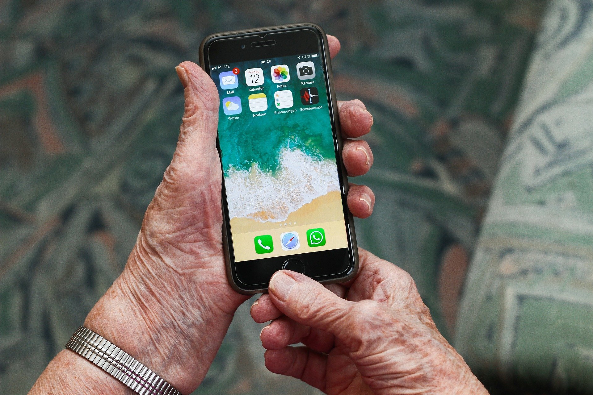 Digitale Teilhabe im altersgerechten Quartier Zu sehen ist ein Smartphone, das von einer älteren Person in der Hand gehalten wird